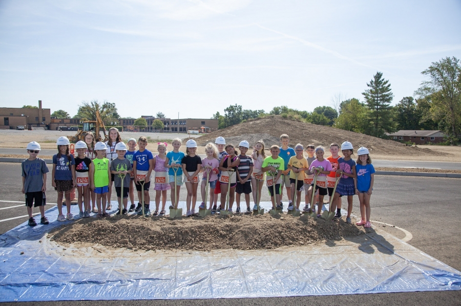 people posing on a pile of dirt